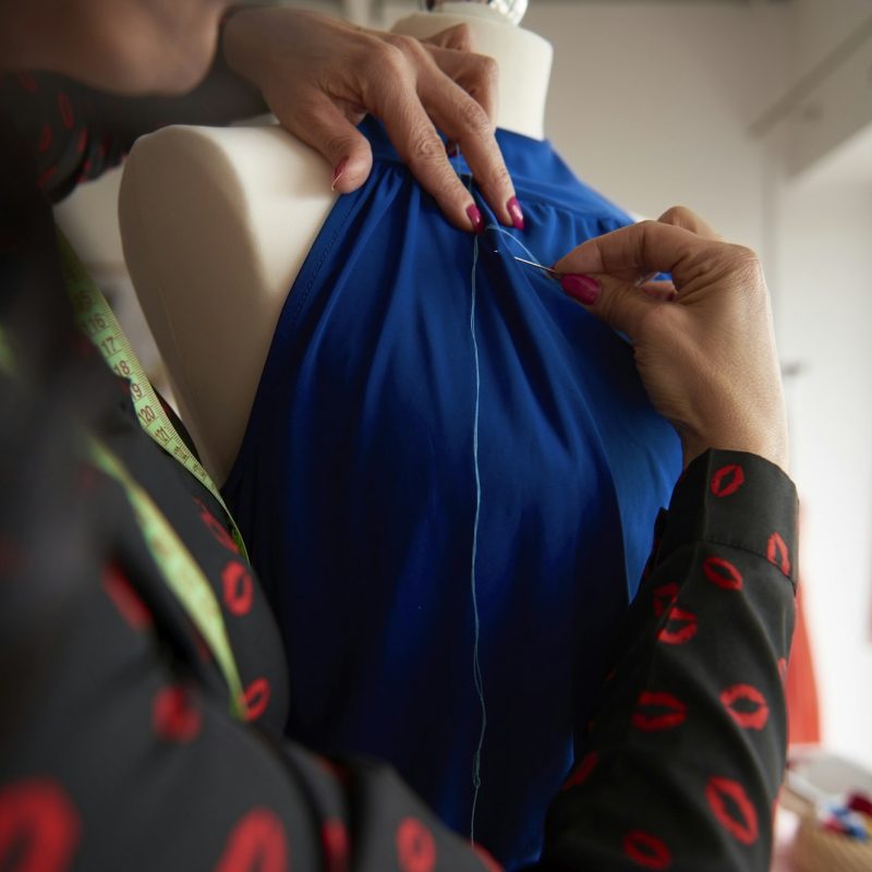 Tailor sewing a blue suit